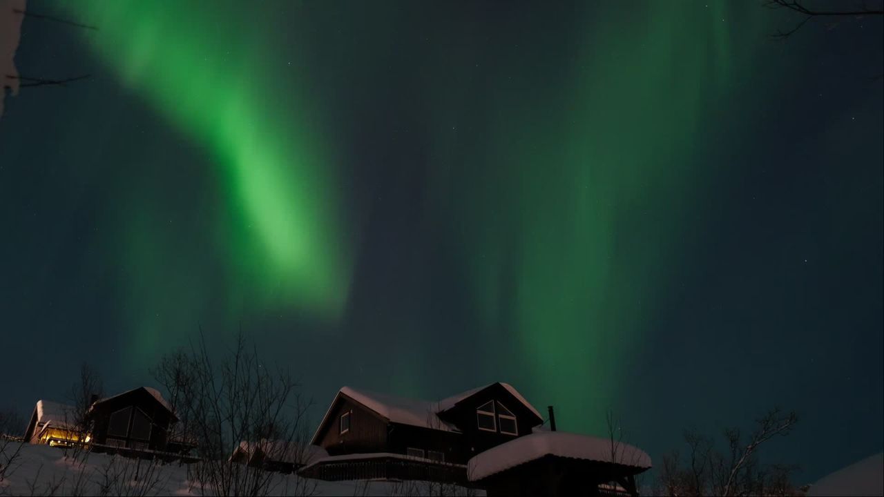 Aurora Borealis Over Snowy Cabins At Night — Pexels video still by Utkarsh Malviya