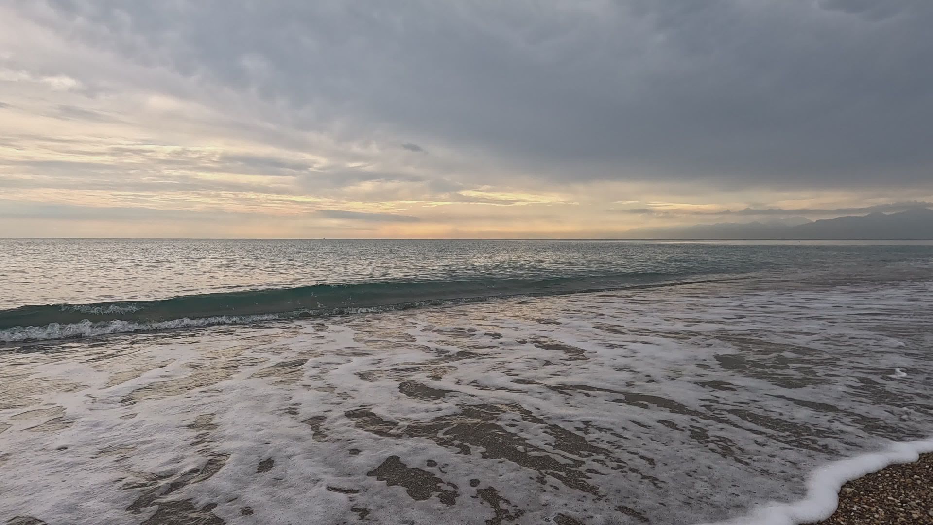 Serene Coastal Sunset With Gentle Waves — Pexels video still by Engin Akyurt